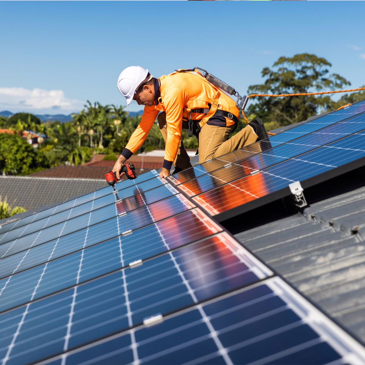 Experts with Triumph Restoration install solar panels on a client's house. 