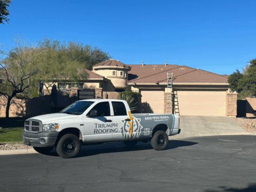 A truck with a prominent logo is one of the many fleet vehicles for Triumph roofing.