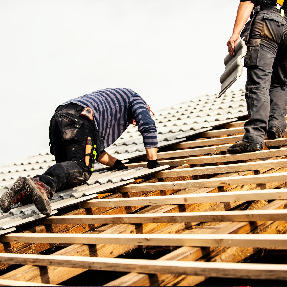 A roofing contractor is installing tiles onto a clients roof. 