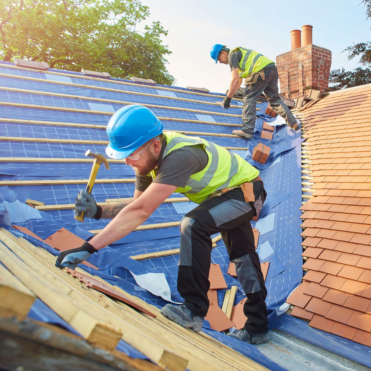 A waterproof membrane is installed by roofing contractors on a client's home. 