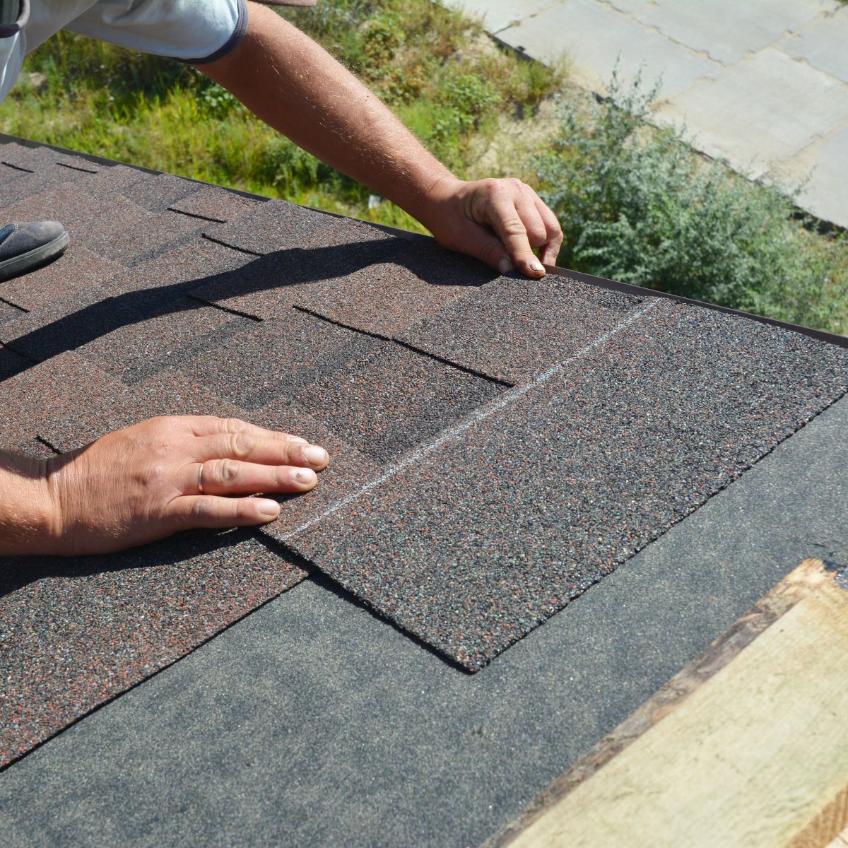 A trusted Scottsdale Roofing contractor with Triumph roofing is installing a shingle tile. 