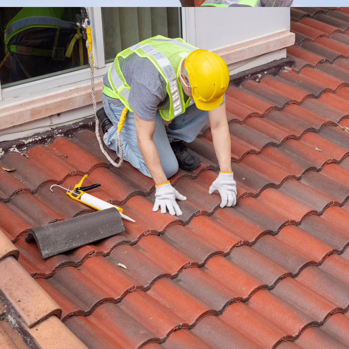 An expert roof installer with Triumph Roofing is working on installing a tile roof on this client's home.